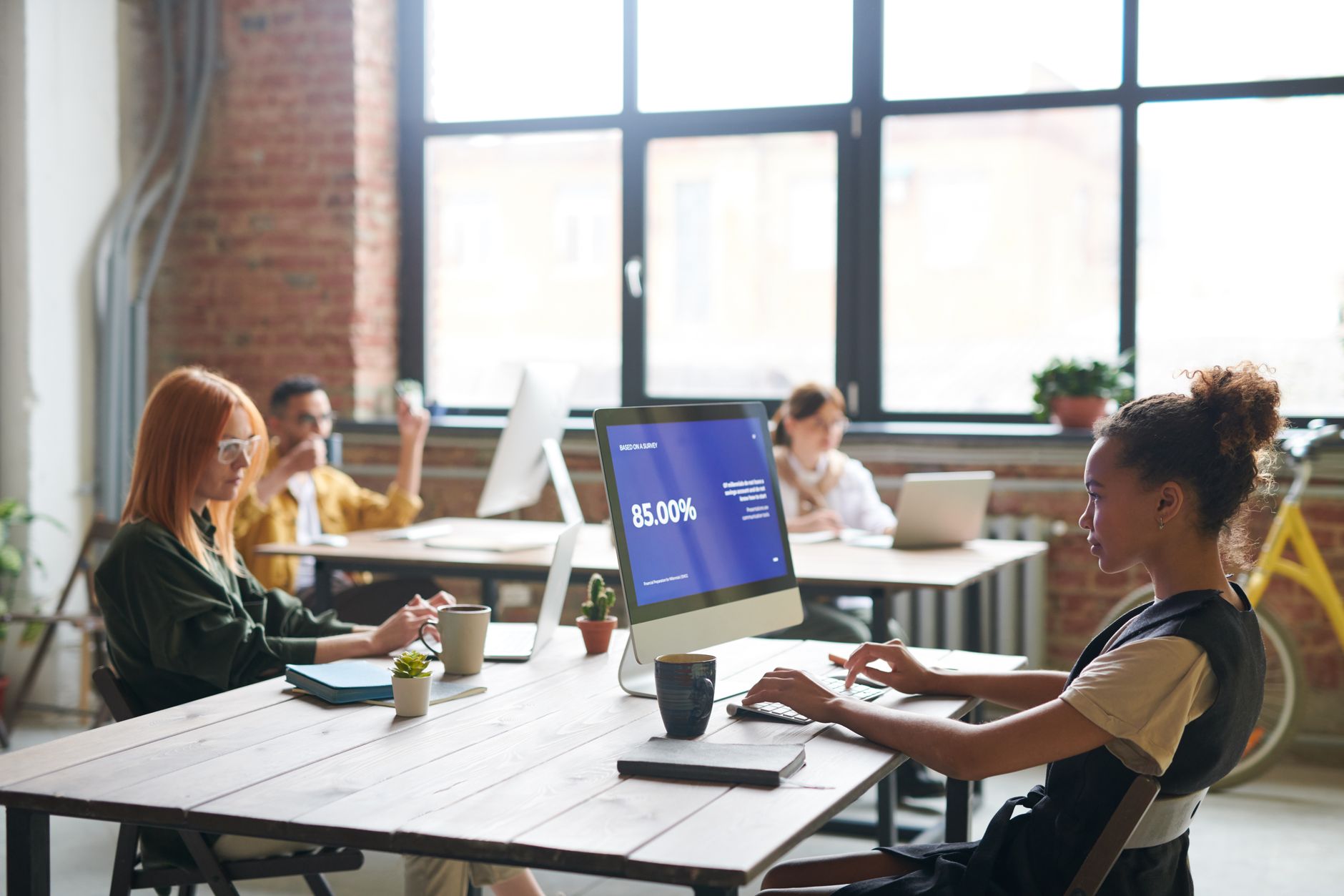 Team collaborating in a modern office setting, focused on a digital display showing 85% progress. — Find Section 8 in New Yor