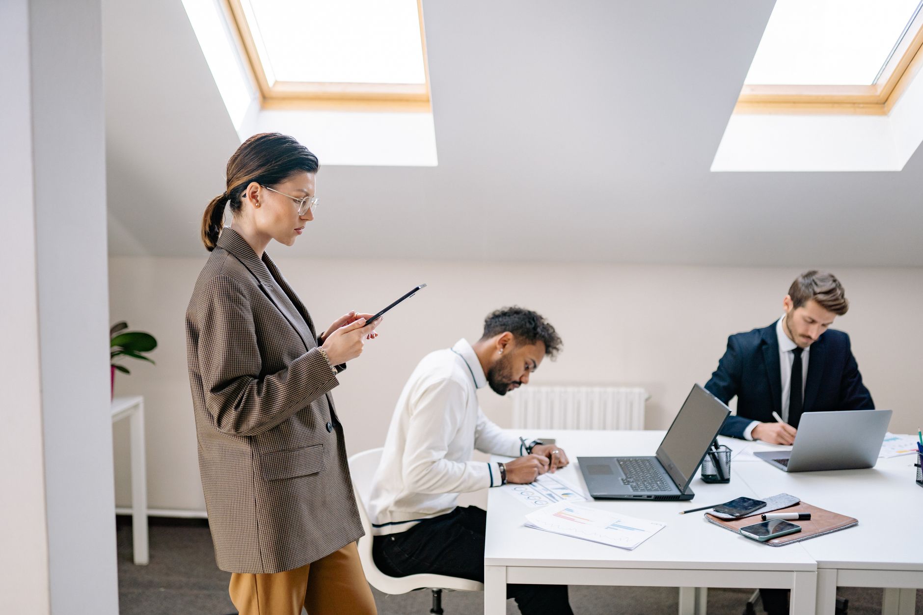 A diverse group of professionals working together in a bright, modern office space. — loft ladders That Enhance Storage Acces